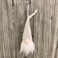 White Nordic Christmas gnome ornament with sequins and white faux fur on wood background - Champagne Gold