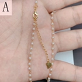 Close-up of a 18K gold plated pearl necklace with a heart pendant held in hand - Pearl Heart Necklace