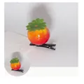 Detail view of a 3cm tomato-shaped hair clip with vibrant red finish and green leaves - Tomato Style
