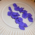 Detailed view of long purple flower petal tassel earrings on a textured ceramic plate - 37# Steel Pin - Purple