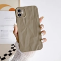 Detailed view of the brown wrinkled texture on the flexible silicone phone case - Coffee / iPhone 15