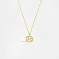 Detailed macro view of gold constellation pendant with white zircon stones on long chain - Cancer