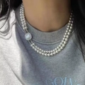 Double-layered gray pearl necklace featuring a square shell buckle on female model - White Glass Pearl Double Layer Buckle / White