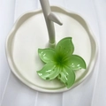 Translucent green frangipani flower hair claw clip displayed on a white tray - Green (Five-point Flower)