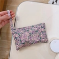 Detailed shot of floral cotton hand pouch with purple and green patterns and carry strap - Purple Floral