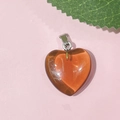 Orange heart-shaped 20mm natural stone pendant with metal ring on pink background - 51-Glass Yellow