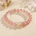 Macro detail of strawberry quartz beads with golden accents on a textured cream backdrop - 10# Natural Stone Nephrite Jade Strawberry Quartz Bracelet