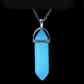 Macro shot of luminous blue hexagonal prism crystal pendant with silver setting - Pendant with O-Chain / Blue