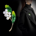 Elegant plant-shaped butterfly brooch featuring seven white pearls and green enamel leaves - Pearl Berry Green Leaf