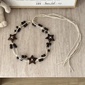 Detail of bohemian braided waist belt featuring brown wooden stars and cream woven cords - Star Coconut Shell - 169cm