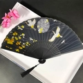 Elegant black bamboo folding fan with crane pattern and tassel in white gift box - Black Crane & Plum Blossom Design (Women's Fan-93)