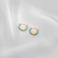 Detail of small gold hoop earrings with light blue enamel spiral texture on white silk - Lake Blue