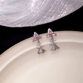 Elegant silver bow earrings with pink zircon stone on a white ceramic plate - Silver with Pink Rhinestone