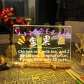Detail view of glowing transparent acrylic LED message board with colorful fluorescent text - Large (30*20cm) - With 1 White Pen