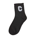 Classic black cotton crew socks with white letter C pattern on a clean white background - Black