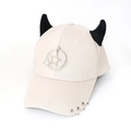 Detail of cream baseball cap featuring black horns, star pendant and metal brim rings - Stars Beige