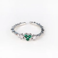 Macro detail of silver adjustable ring with three green heart-shaped cubic zirconia stones - Three-Heart Green Gemstone White Gold Style (Style 21 White Gold)