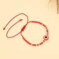 Detail of red woven beaded bracelet with Evil Eye charm and adjustable drawstring closure - Type I-Red Evil Eye