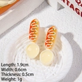 Detailed view of miniature resin hotdog toy with dimensions 1.9cm in a white spoon - Cream Spoon