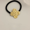 Elastic hair tie with gold textured clover metal ornament in a vintage style - Patterned Clover Gold