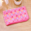 Close-up of pink flannel pet blanket with star patterns folded on a wooden floor - Pink Star