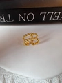 Macro shot of double-layer golden beaded ring on a white textured surface - 18K Gold
