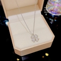 Silver four-leaf clover necklace with zircons displayed in a beige jewelry gift box - X641 Silver Clover Zirconia
