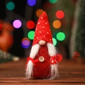 Close-up of a handmade Christmas gnome with a red polka dot hat and a wooden button detail - Red Polka Dot Hat Style