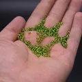 Grass green silver-lined glass seed beads held in hand for DIY jewelry making - 3mm / 15g / Light Green