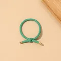 Detail shot of green braided elastic hair tie with elegant gold metal tips on beige background - Ribbed Knot - Metal Buckle / Bright Green