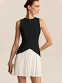 Detail of elegant waist pleats on women's sleeveless black top and white mini skirt - Black and White