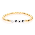 Detailed view of gold beaded bracelet with LOVE letter charms on a clean white background - 4mm Gold Copper Beads-LOVE