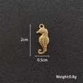 Macro view of gold seahorse charm with dimensions 2cm by 0.5cm and 0.8g weight - Seahorse