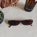 Retro tortoiseshell oval sunglasses with dark lenses on minimalist textured background - Tortoiseshell 20