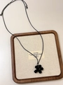 Detail of a black floral pendant necklace with adjustable cord in a wooden jewelry tray - Simple Five-Petal Flower (XL0589)