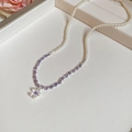 Macro shot of pearl and purple flower pendant necklace with elegant bead details - Silver Purple