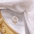 Detailed view of a handmade freshwater pearl ring with a dangling gold vertical charm - Letter I