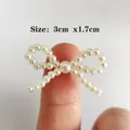 Mini pearl bow accessory for DIY jewelry and apparel, size 3cm x 1.7cm in pearl white - Pearl Fingertip Bow