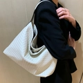 White hand-woven large capacity tote hobo bag styled on a female model shoulder - White