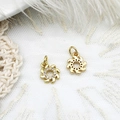 Macro shot of sun pendant with gold plating and cubic zirconia on lace background - Wheel