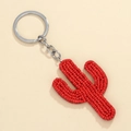 Detail shot of handcrafted red beaded cactus keychain with silver metal ring - Red