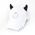 Detail of white baseball cap with black devil horns, metal star ring and brim piercings - Star White