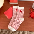 Festive red and white plaid crew socks with lucky Fu character on wooden table - One Size / Fortune
