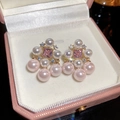 Detailed macro of gold-plated square pink gemstone earrings with dangling pink pearls - Pink Pearl Style (47#)