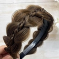 Macro view of fishtail braid headband in dark brown synthetic hair on black anti-slip base - Tan