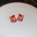 Macro view of festive red lucky bag stud earrings with gold trim and sparkly crystals - Rhinestone Lucky Bag Stud Style (61# Silver Earring Post-Gold-Red)