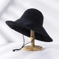Detail of a black wide-brim sun hat with adjustable windproof cord on a wooden stand - M(56-58cm) / Upgraded Black (21I021)