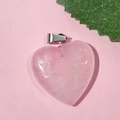 Pink heart-shaped natural stone pendant with metal bail on pink background - 20-Rose Quartz