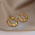 Luxury gold chunky hoop earrings with irregular lava texture on champagne silk - Gold Crumpled Hoop