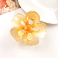 Detailed view of translucent amber frangipani hair claw clip with golden metal spring - 5-Petal Flower Milk Yellow